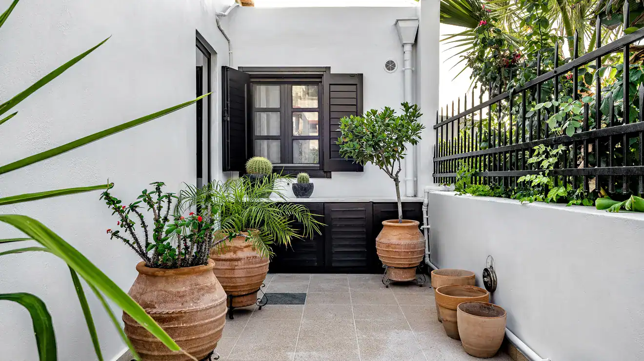 Small tiled terrace with flower pots