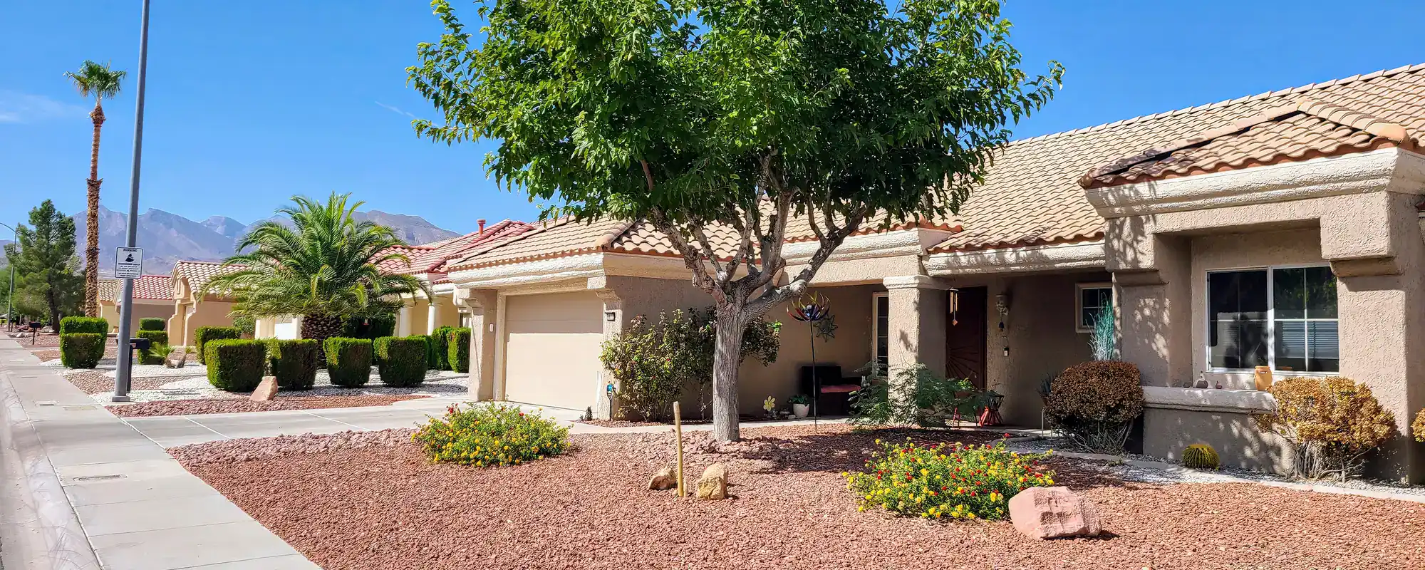 Desert home and landscaping with a mountain view
