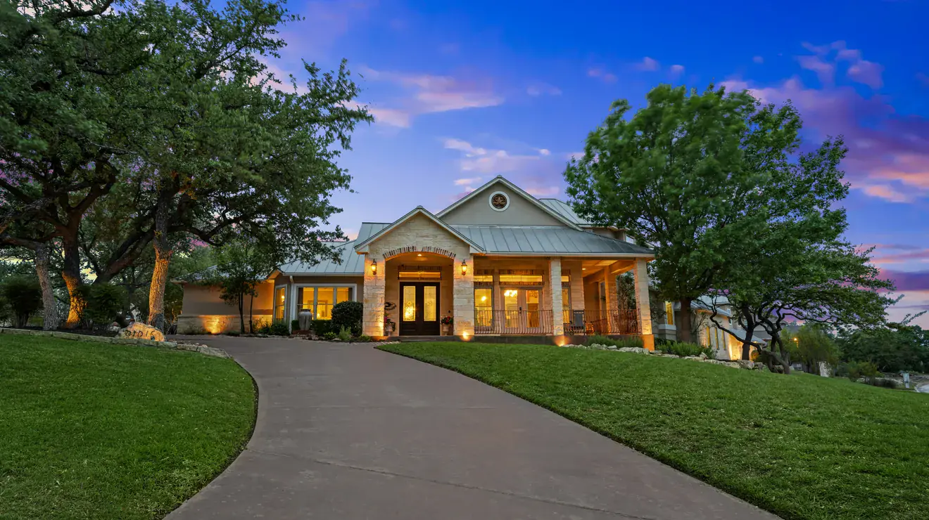 Home exterior lit at sunset