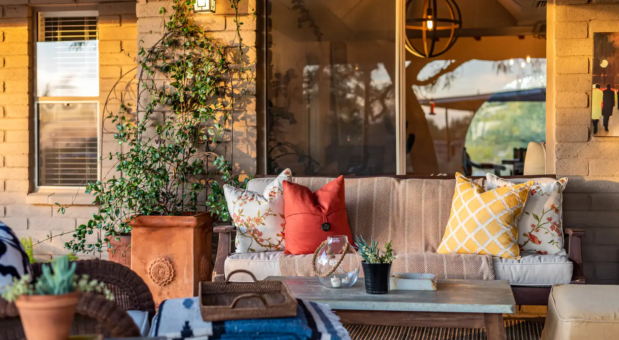 Desert patio at sunset with cactus and potted plants