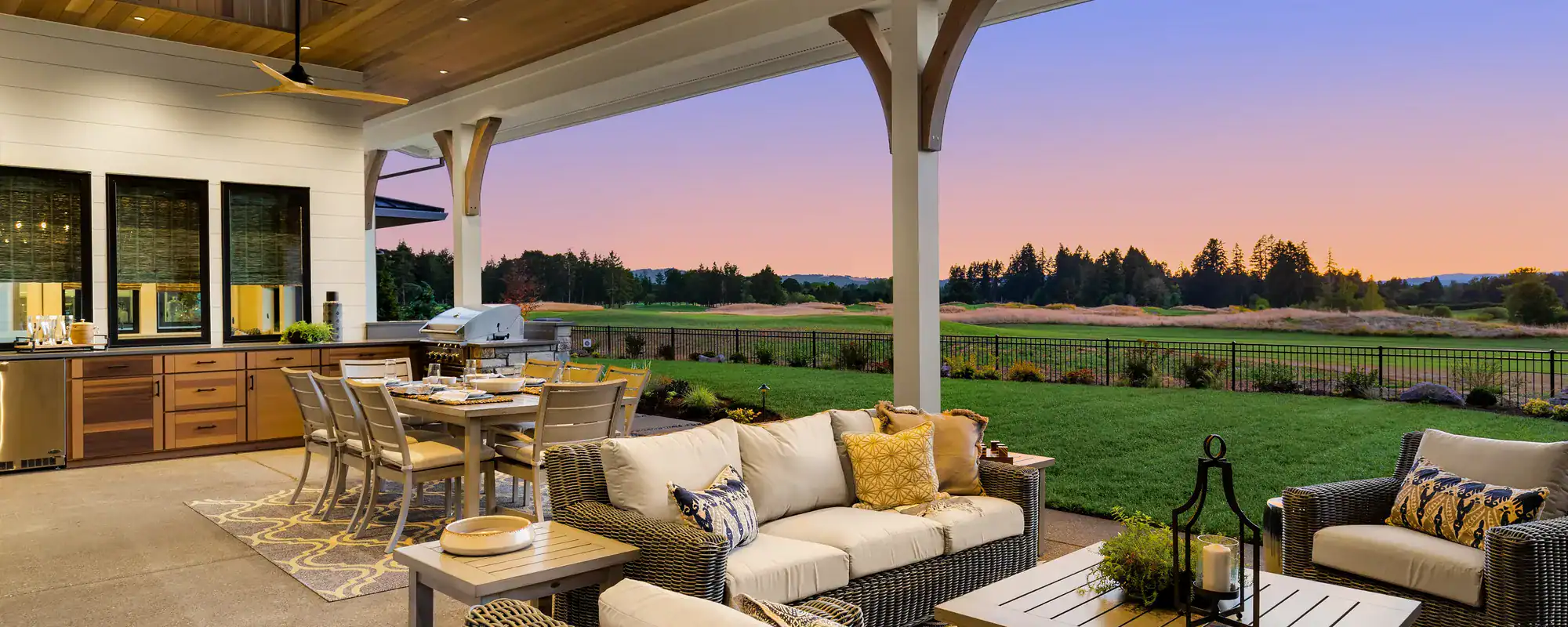 Covered outdoor kitchen and patio at sunset