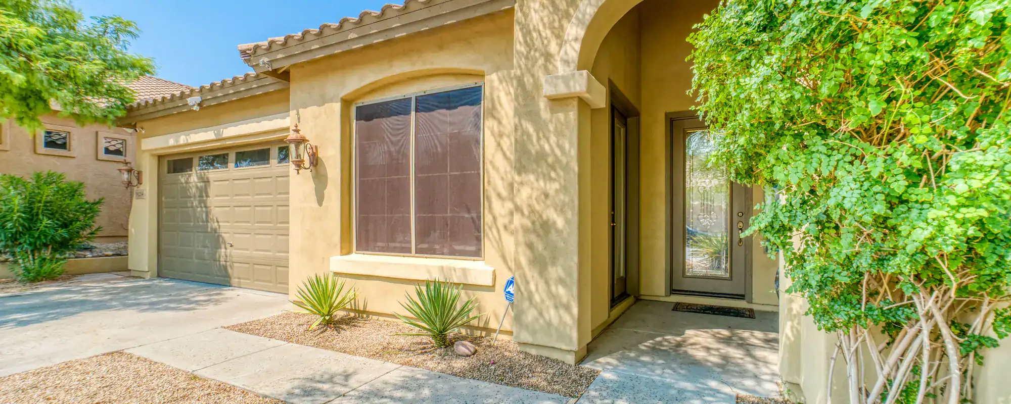 Desert-style home with an arched entry