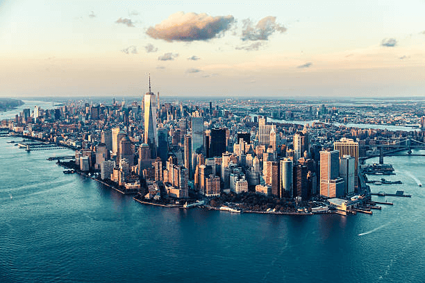 Aerial view of Lower Manhattan surrounded by water at sunset