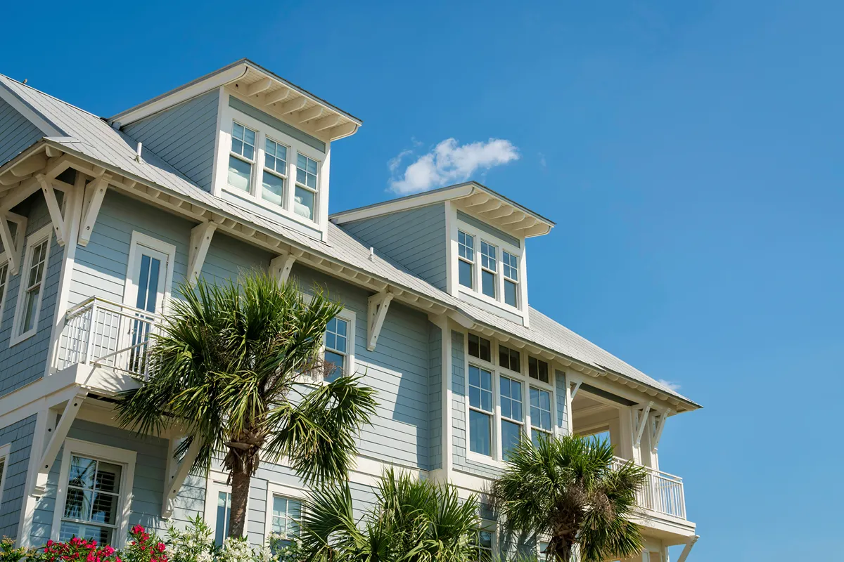 Low angle view of a house with light blue wood sidings and white trims at Destin, Florida