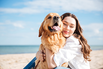Woman with Dog on the Beach