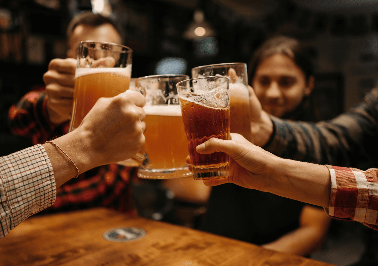 Group of friends drinking beer while they share cheers. 