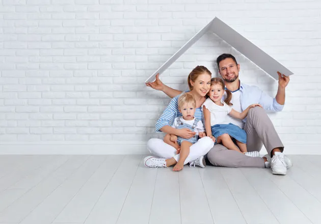 family under cardboard roof