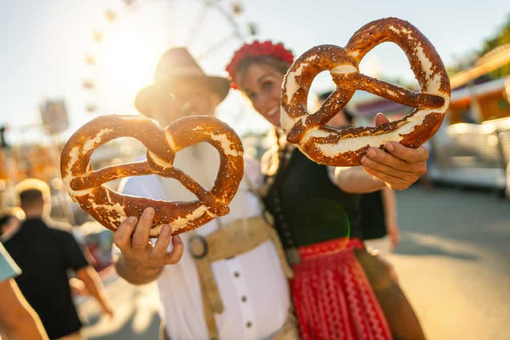 Two People at a Fair with Pretzels
