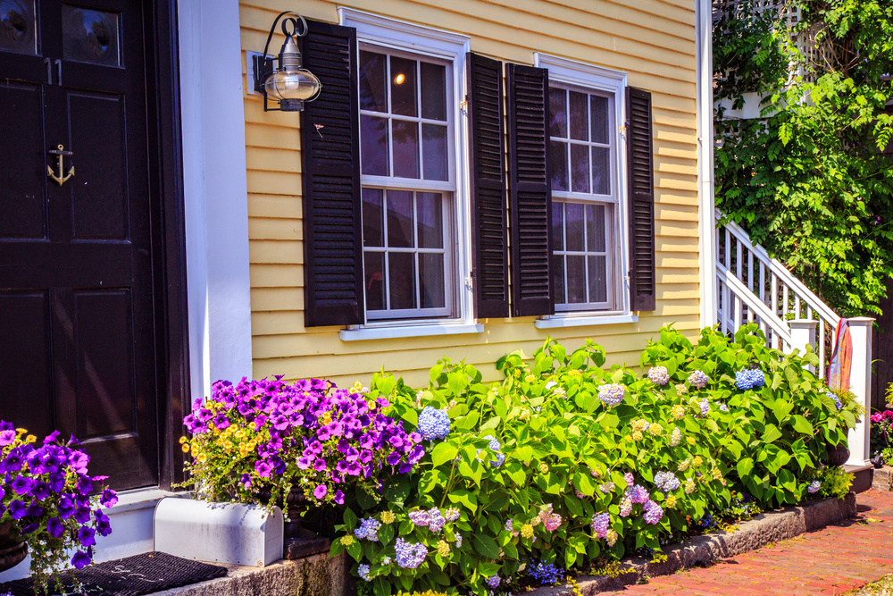 Yellow New England Home with Flowers