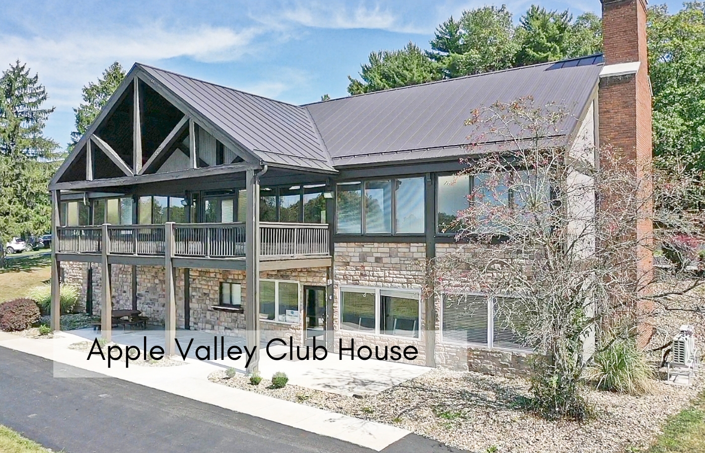 Apple Valley Clubhouse exterior with a covered porch and stone lower level.