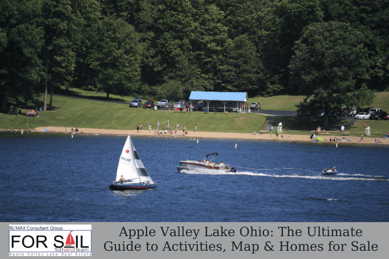 Sailboat and pontoon boat on Apple Valley Lake Ohio near a sandy beach, showing lake activities and community lake life.