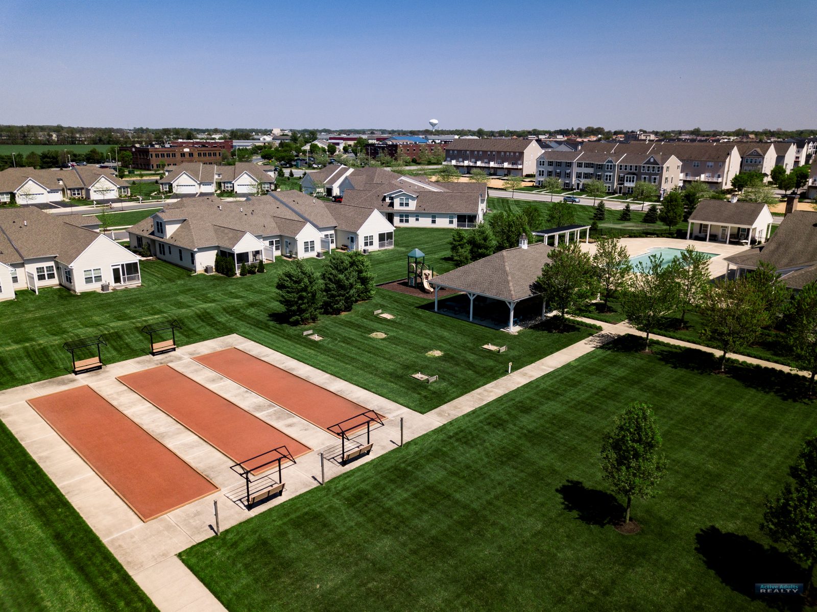 Drone view of the bocce courts and lawn beside the Spring Arbor clubhouse