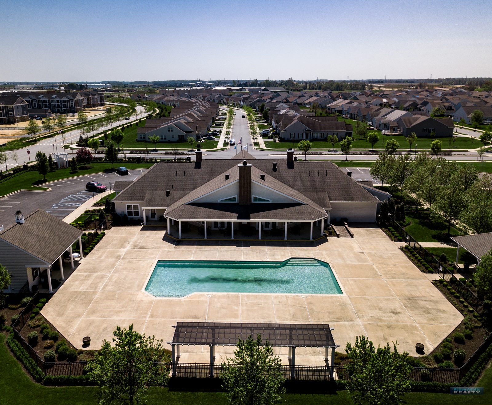 Drone view of the outdoor pool and pool deck behind the Spring Arbor clubhouse