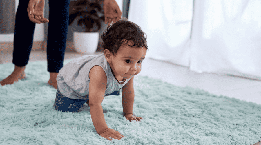 Baby crawling on a rug