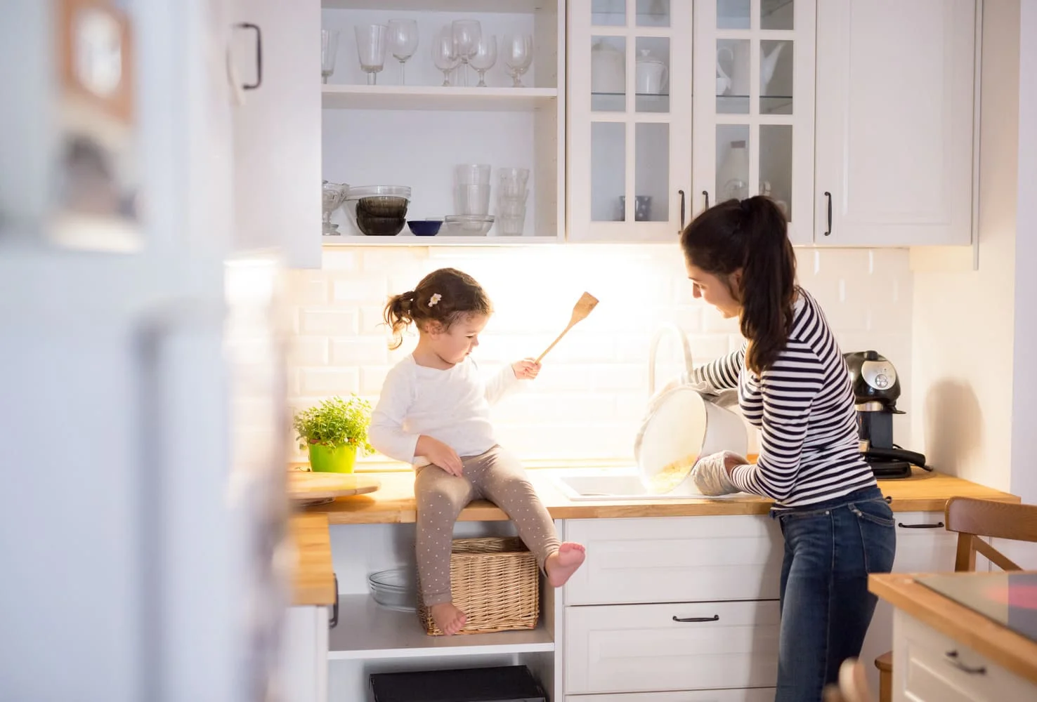 Mouther with daughter on the kitchen