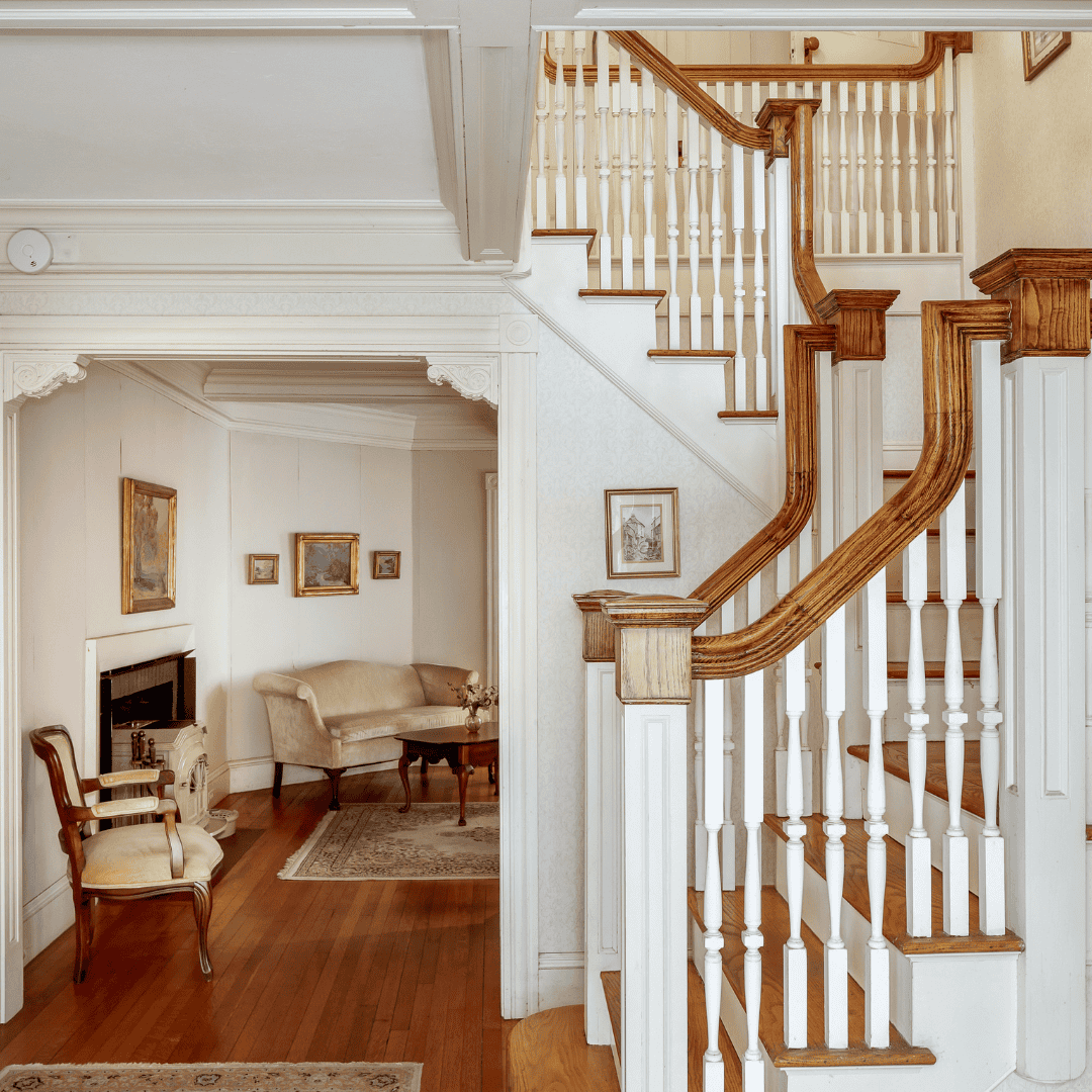 Warm white interior with wooden custom staircase, Rockport, Maine 
