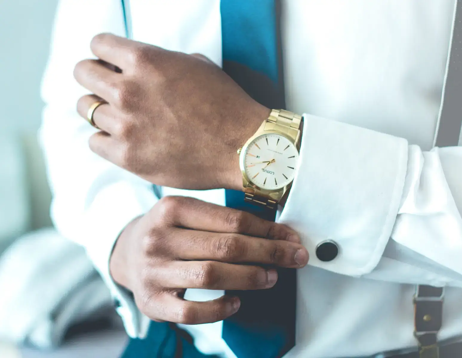 man in suite with watch on the hand