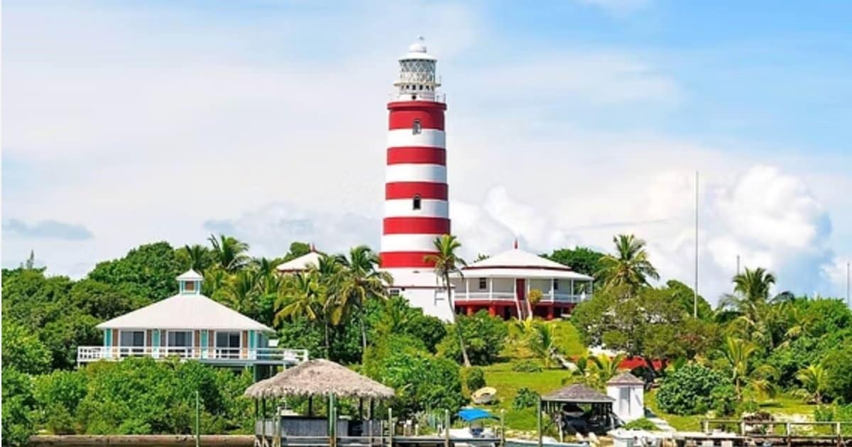 Elbow Cay Hope Town Abaco Bahamas — iconic red and white striped lighthouse and waterfront real estate