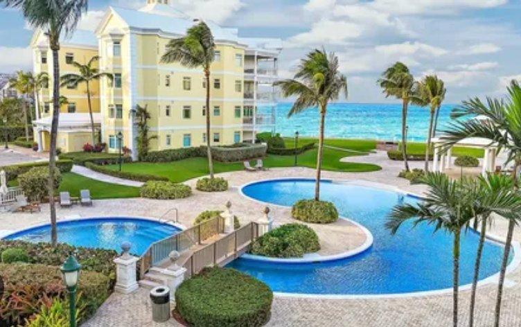 Nassau condos for sale Bahamas — beachfront pool community qualifying for permanent residency