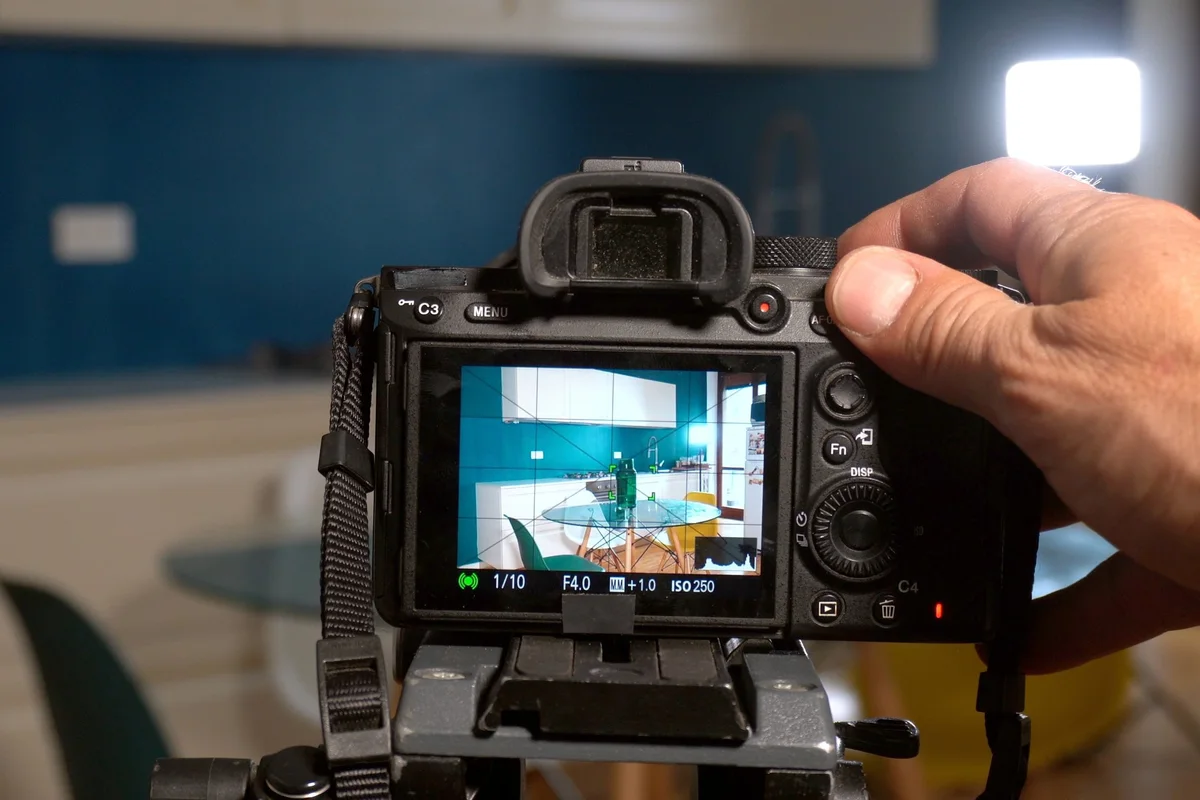 Photographer capturing a home interior with a camera on a tripod