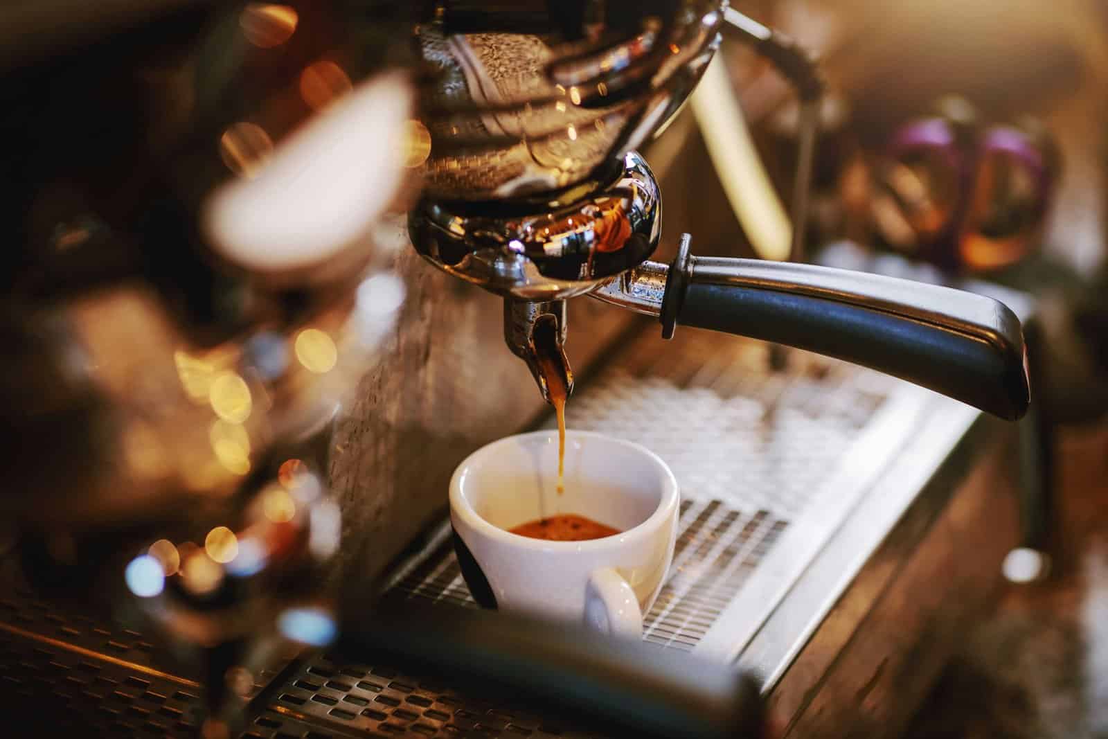 Fresh espresso pulling into a white demitasse at a Denver specialty coffee bar