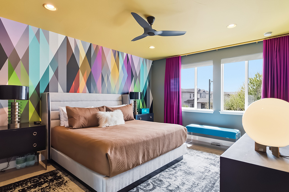 Bedroom with bold wall treatment and personal furnishings before staging, Denver listing