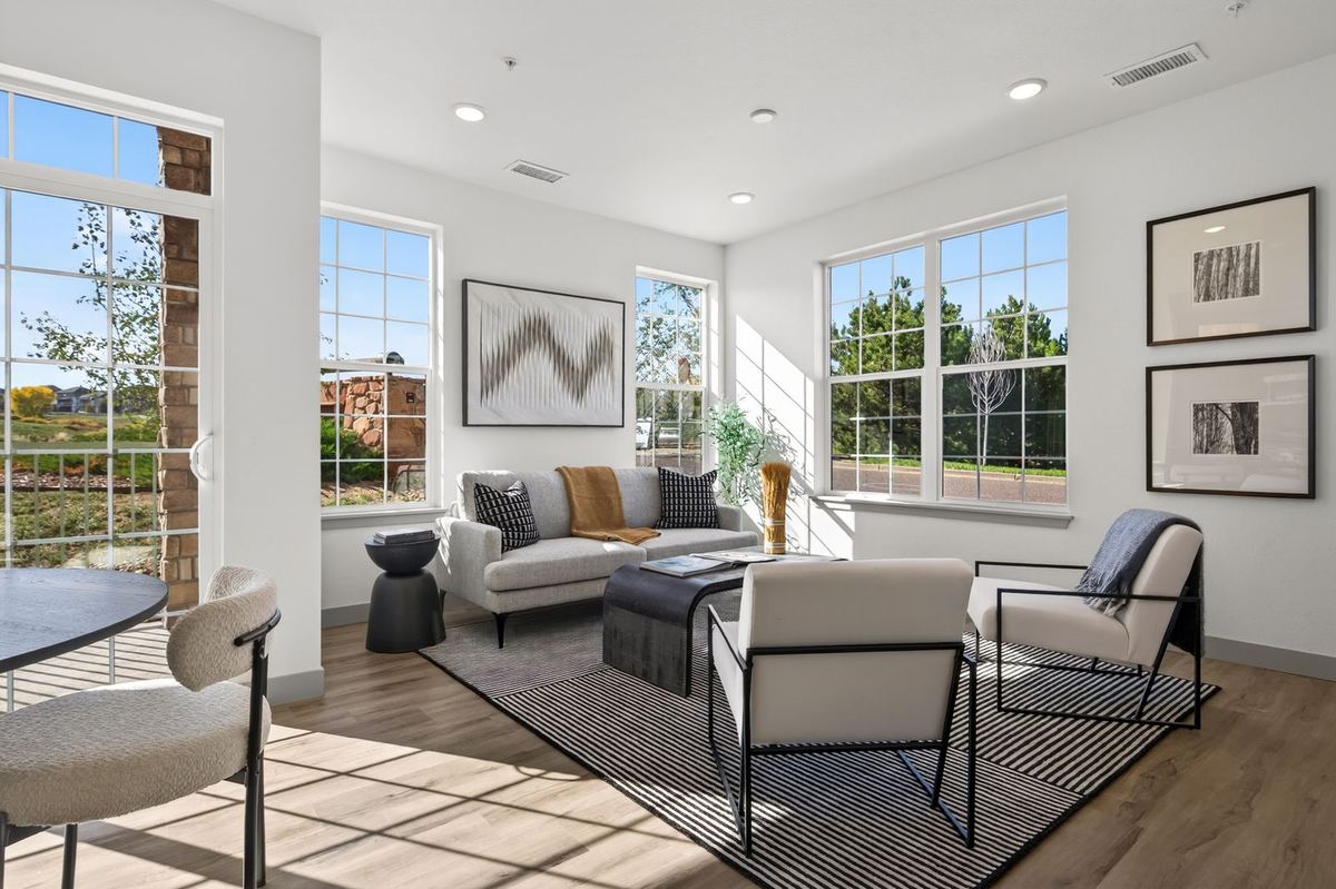 Bright living room with large windows in a Hunters Chase condo