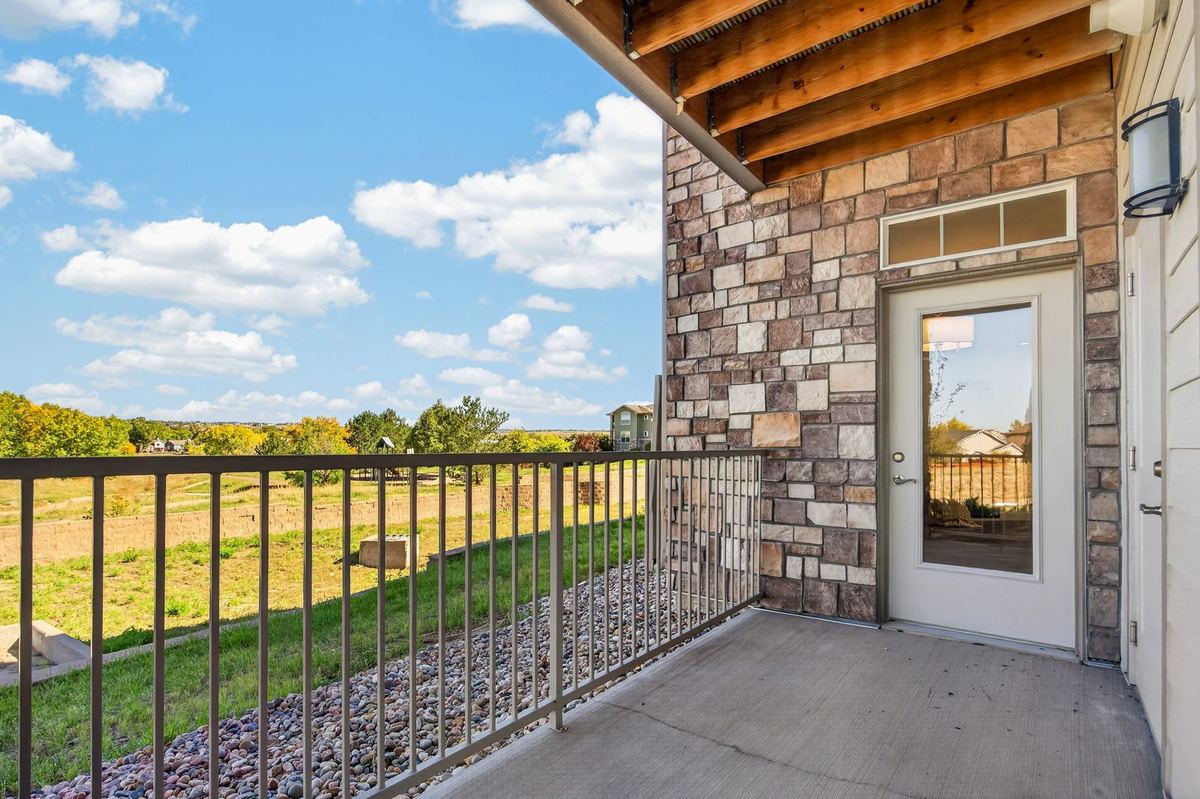 Covered balcony overlooking open space at Hunters Chase