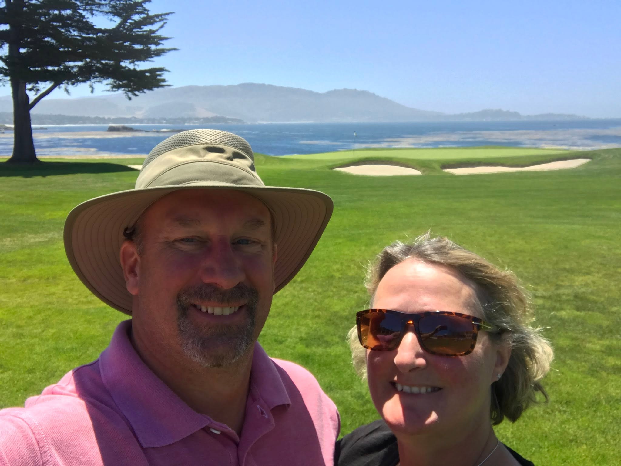 Jack Hathaway and Elizabeth smiling on an oceanside golf course