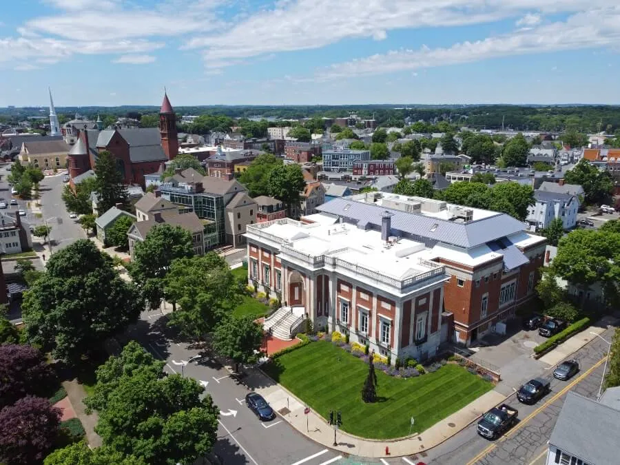 Beverly Public Library aerial view at 32 Essex Street with Cabot Street at the background in historic city center of Beverly, Massachusetts